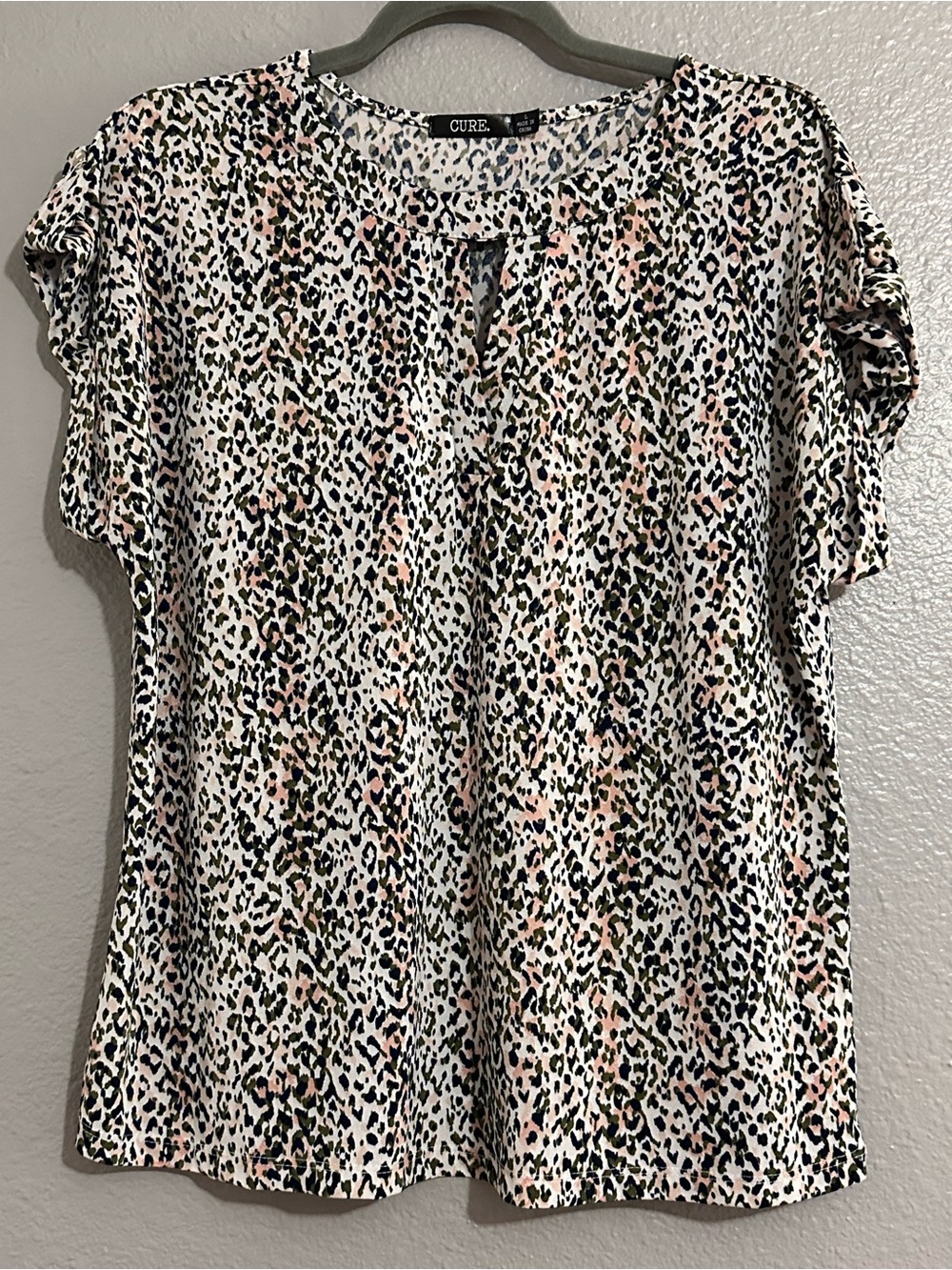 Cure. Women's Leopard Print Keyhole Blouse in White and Black with Pink Accents
